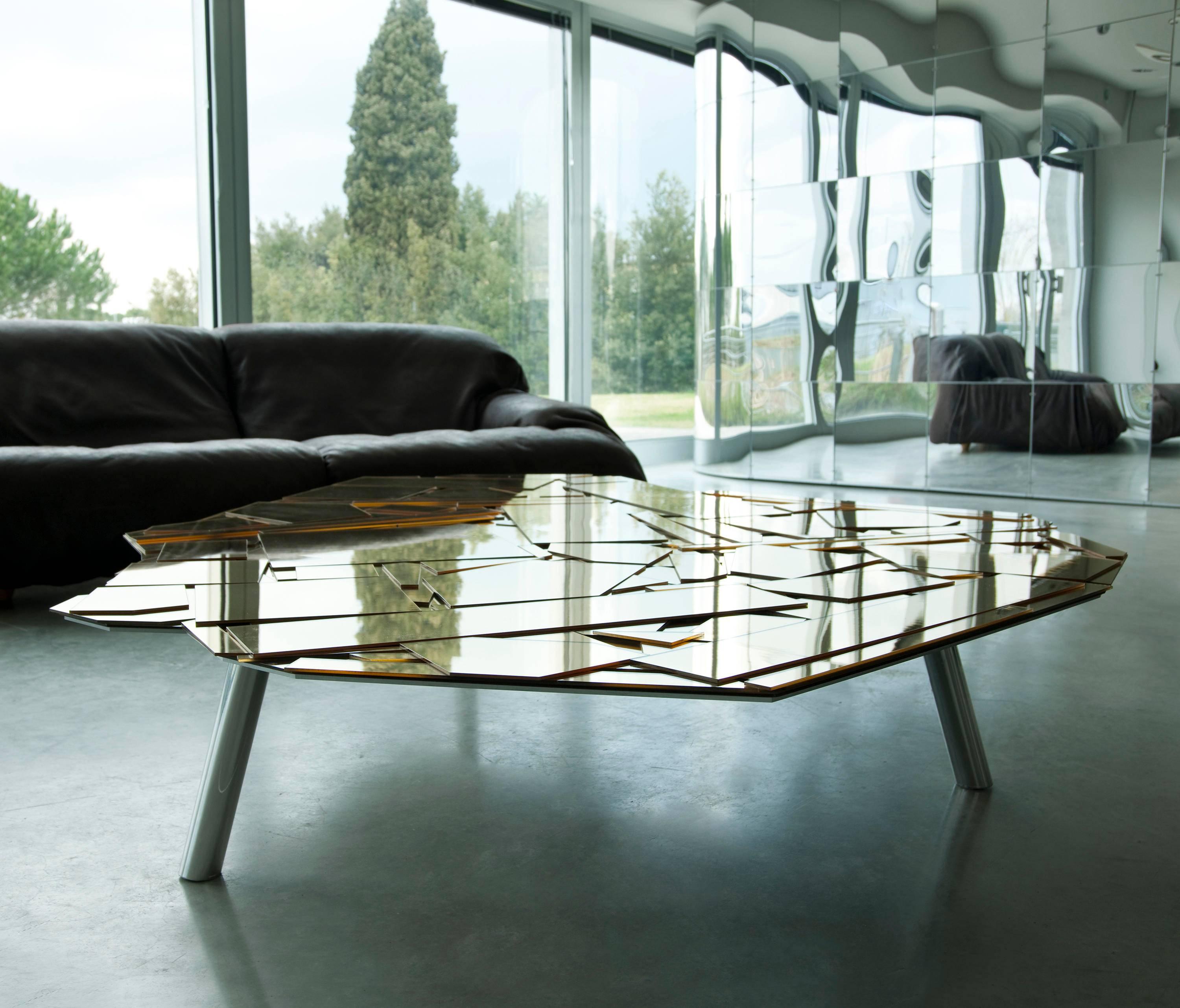 Coffee or side table characterized through an irregular top available in various sizes and heights. Aluminum covered with laser-cut Coloreflex methacrylate forms with a mirrored finish. Inclined legs in glossy brushed aluminium.

A table with an