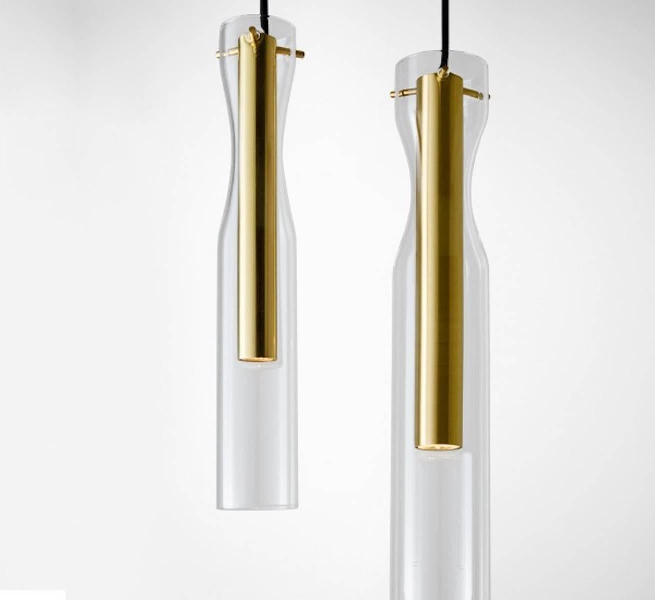 Hanging lamp with LED light (4 Watt). Handshaped glass cylinders. 

Interior is available in bright, satin, hand burnished, black chromed or coppered brass. Supplied with 4 meter long cable.

Two sizes available: 
Inch 
Small Ø 2.5 x 14.75 h 
Large