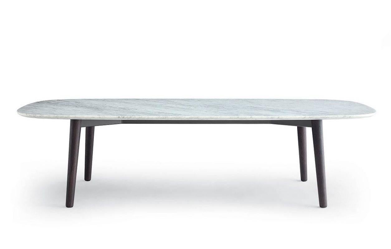 A large table with rounded lines that plays on the contrast between the top, with its light, almost hanging image and the solid, robust frame. Finishes as per the specs provided. 

Prices will vary based on final combination selected. 

Size