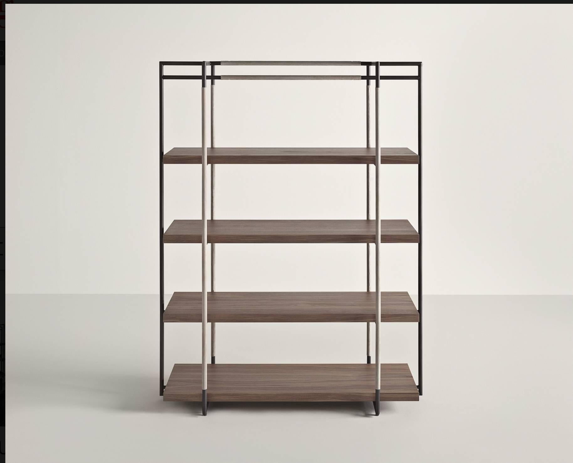 Bak bookcase in walnut, steel and leather in various colors
by Ferruccio Laviani.

Bookcase with a lacquered steel frame upholstered with leather and walnut shelves.

Dimensions: H 165, W 128, D 48.
