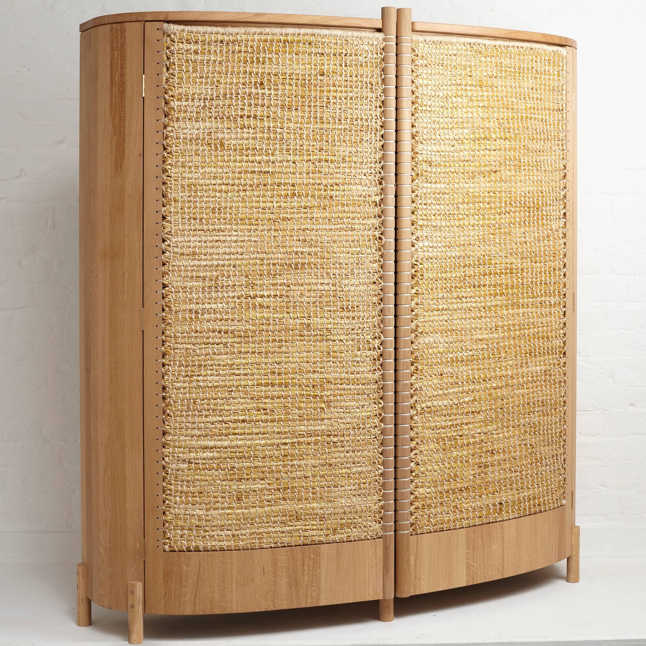 Warming cabinet by Gareth Neal & Kevin Gauld. A finely crafted oak framed cupboard with gently curved doors featuring stunning woven straw panels.

Part of the Brodgar series, the "Warming" Cabinet is the product of a collaboration