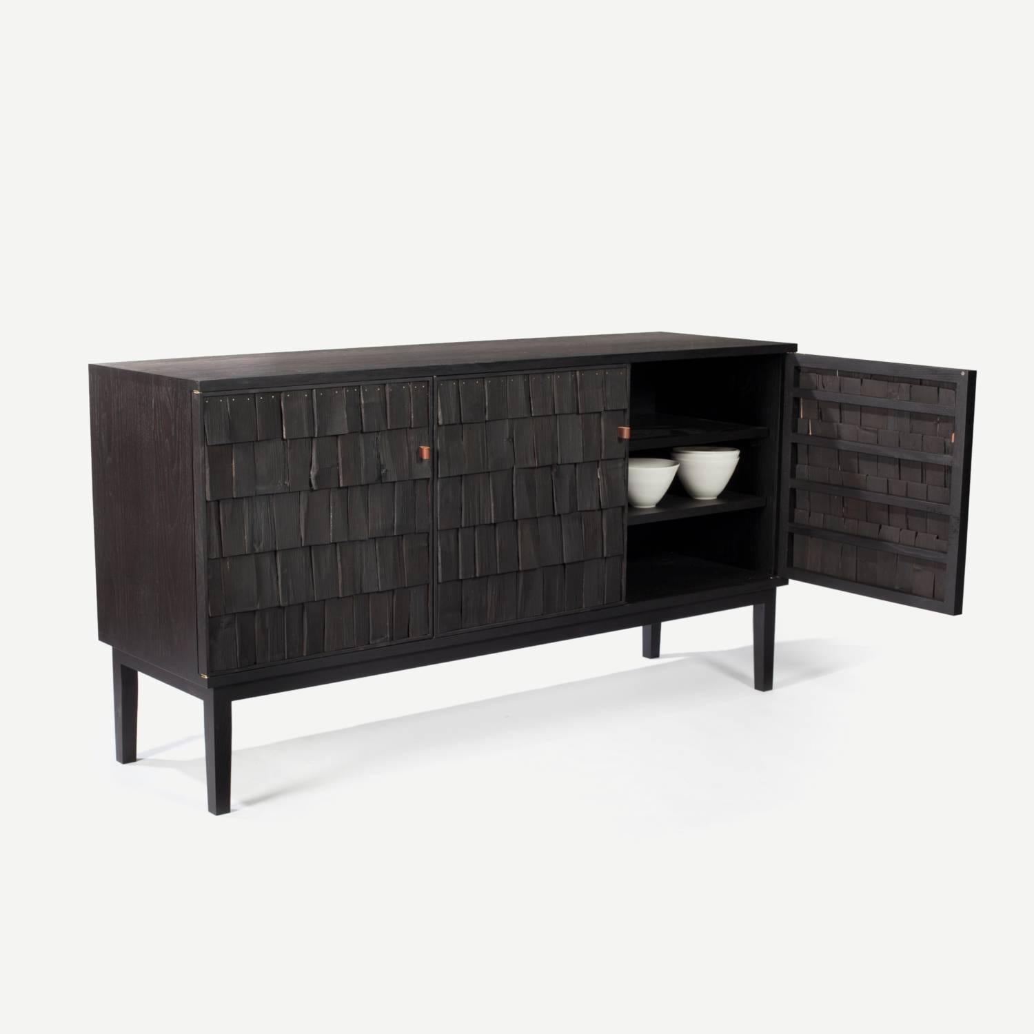 Scorched “Shake” sideboard by Sebastian Cos and Benchmark Furniture. A contemporary sideboard cabinet constructed with blackened shakes in chestnut and ash timber. Blackened exclusively for The New Craftsmen, each shake – a type of shingle commonly