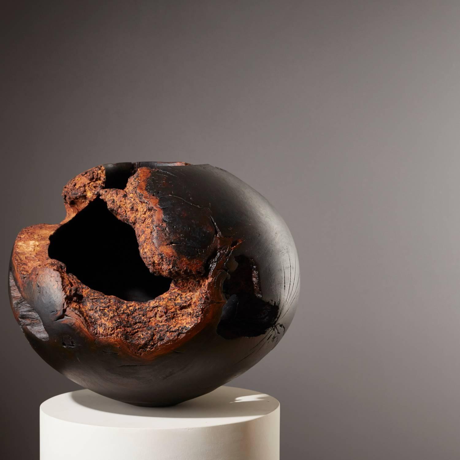 Scorched hollow vessel made from a single section of windblown Mulberry that has been lathe-turned using hand-held gauges. Hollowed from green timber (fresh living wood) leaving behind the natural edges of the gnarled trunk.

Scorched with a flame