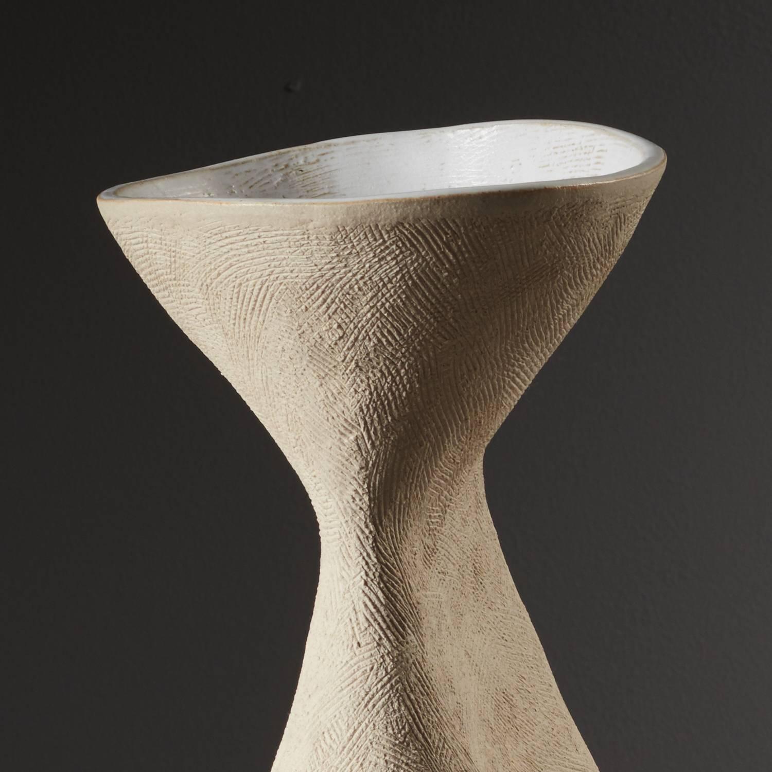Winter Queen Vessel' by ceramicist Iva Polachova, is an elegant tactile form, with a unique character. Coiled and crafted with simple scraping tools. This vessel has been crafted to convey the “stillness and majesty of Winter”. Focused on teasing