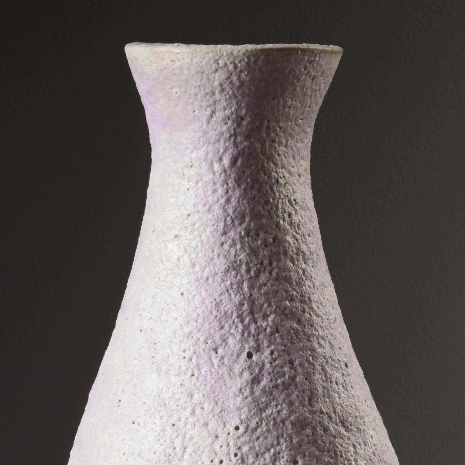 Pink Snow Vessel by ceramicist Iva Polachova, a textured piece of stoneware with a distinct volcanic glaze. A unique piece which has been coiled and crafted with simple scraping tools.

This vessel has been crafted to express the “play of light on