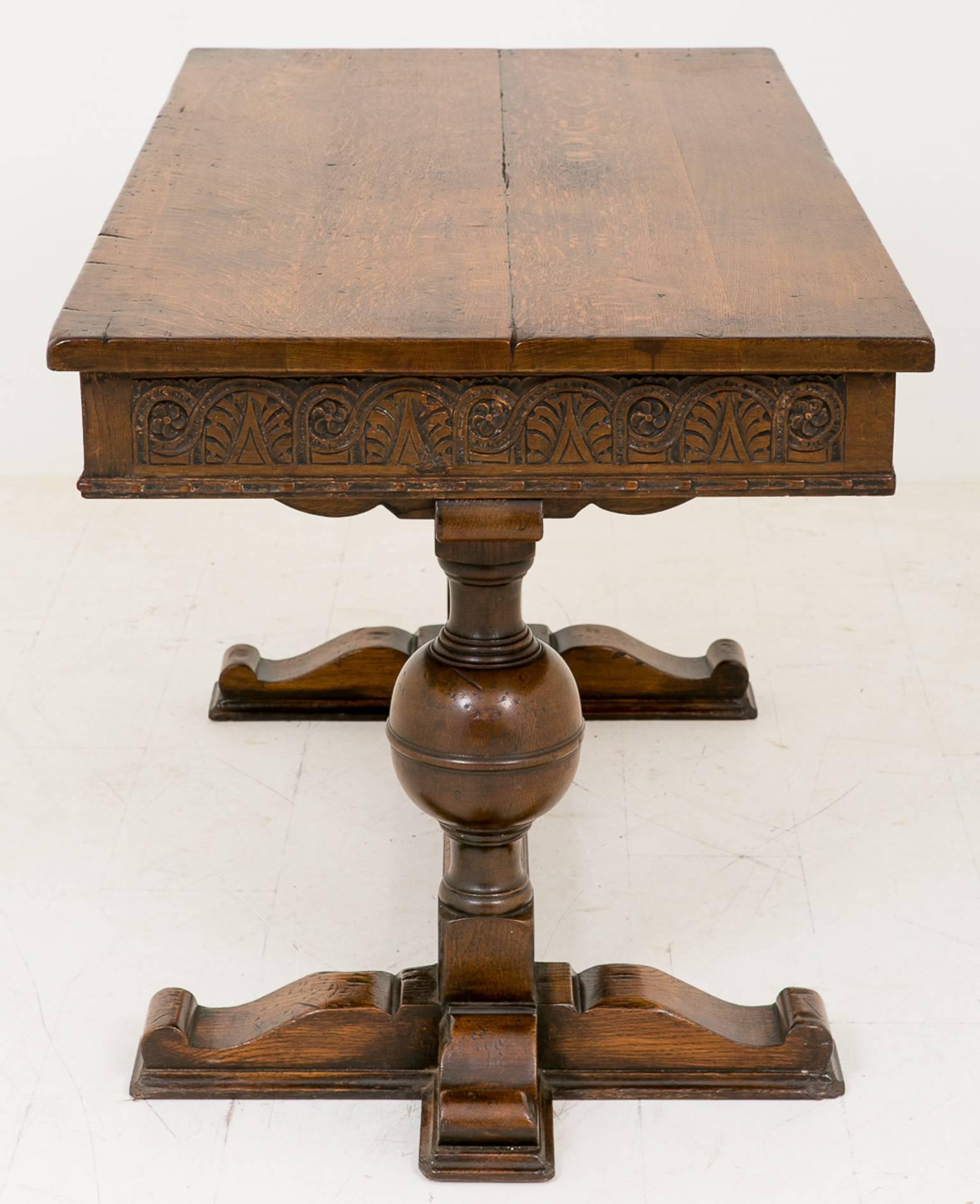 Jacobean style carved oak two-drawer side table.
Featuring a cross section base with bulbous supports having two drawers above.
Adorned in carved decoration.

Size:
Width 58" (147cm)
Height 30" (76cm)
Depth 28" (71cm).
