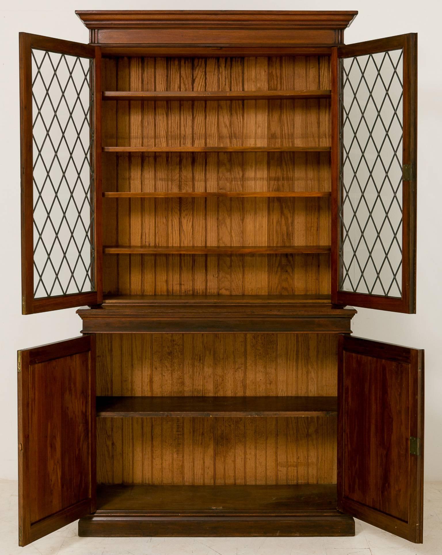 Late Victorian Walnut two door bookcase, standing on a plinth base, two fielded panelled doors.
the top section having four adjustable shelves and leaded glass doors.

Size:
Height 90