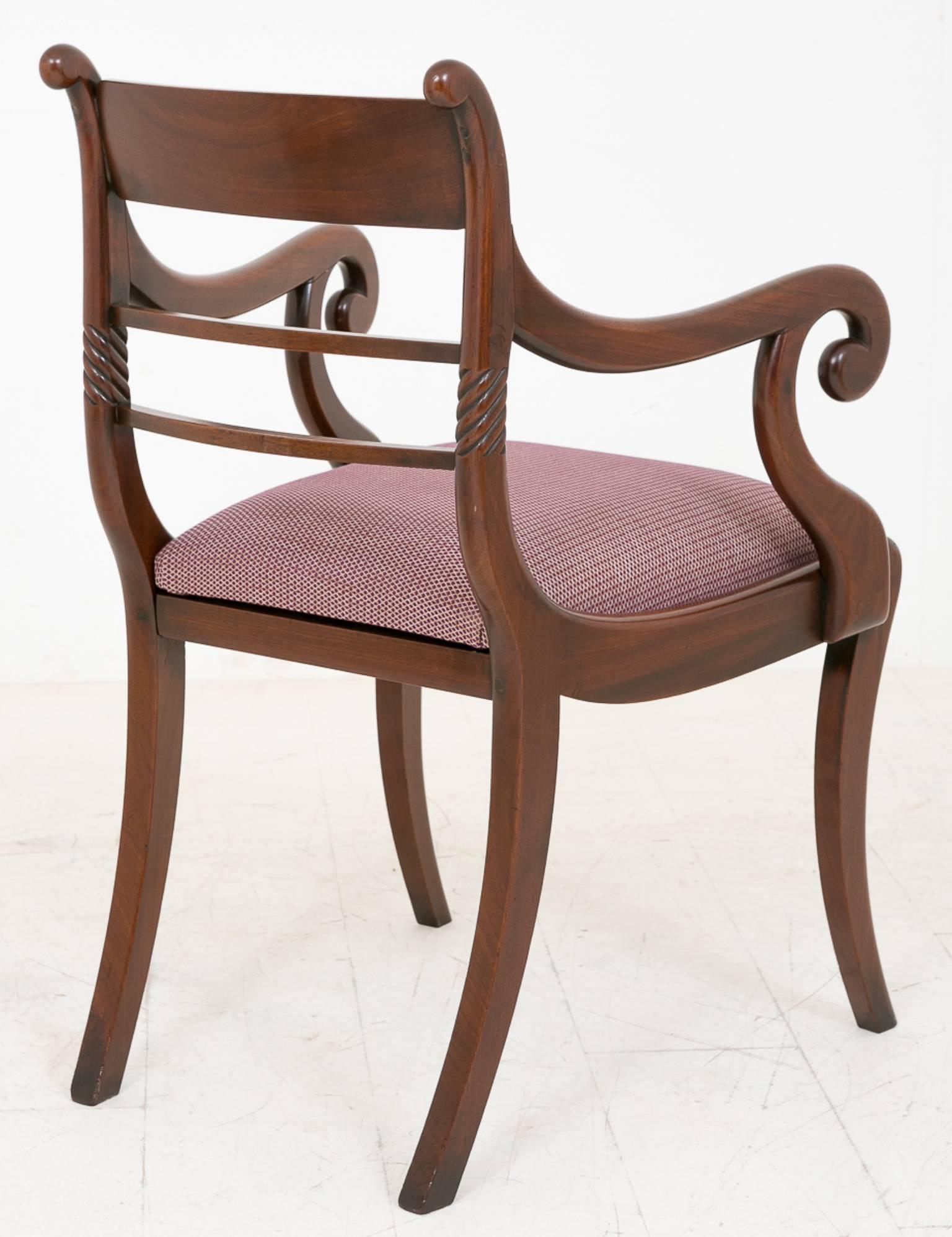 Pair of Regency mahogany library chairs.
Standing on Sabre front legs, lovely shaped arms and the upper cresting rail having a highly figured mahogany veneer.
These chairs have recently been Re upholstered.

Size:
Height 34