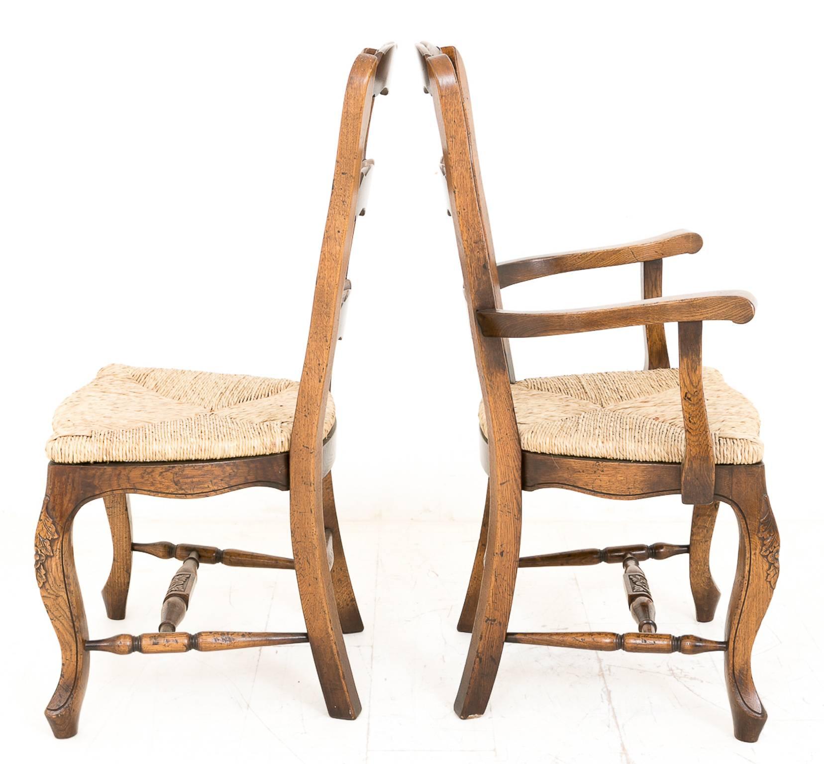 A very nice set of oak French Country chairs. 
Each chair standing on a carved swept leg with turned carved stretcher rails.
The rush seats have been refurbished.
The Ladder backs having a carved cresting rail.

Size:
Singles
Height 40