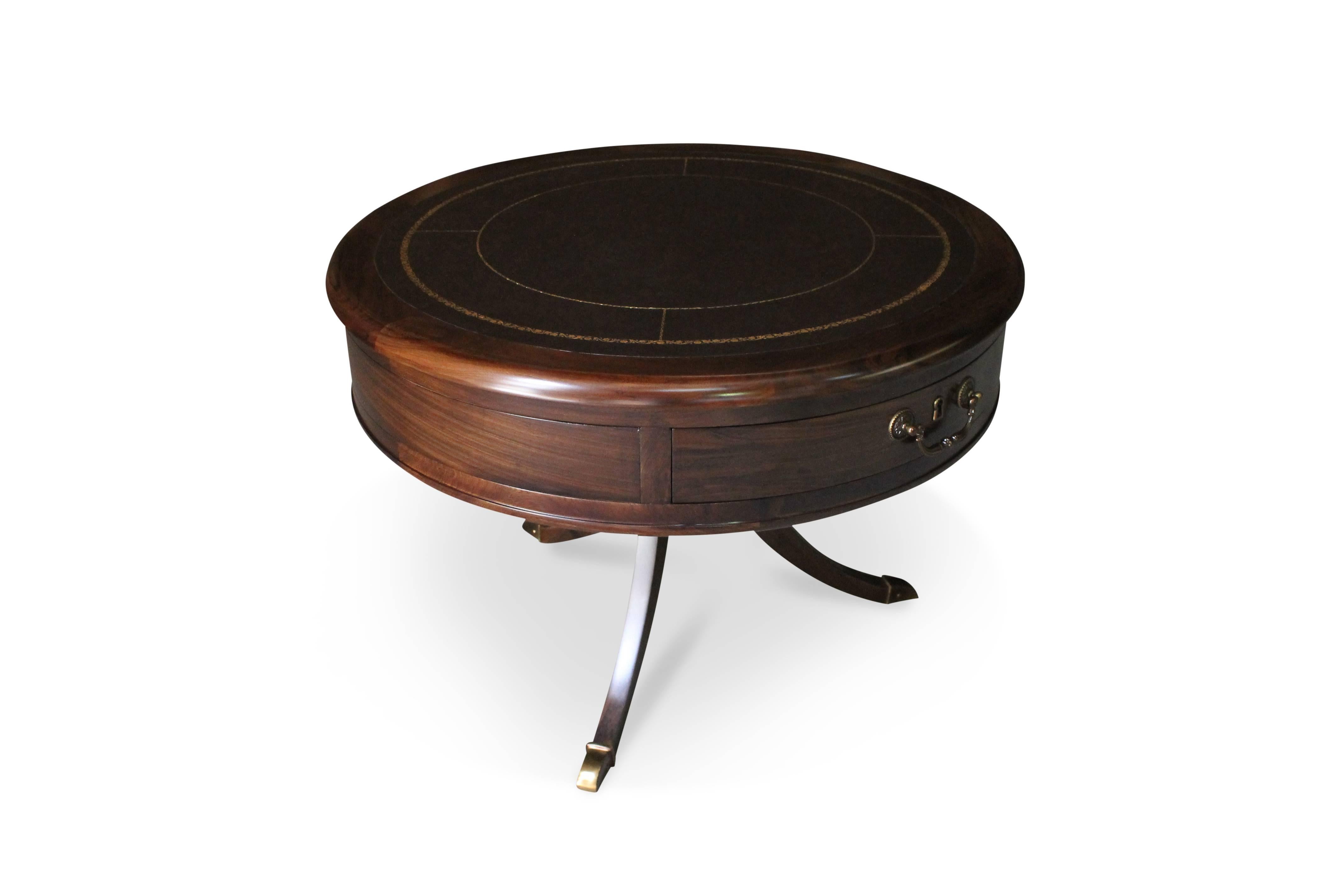 The Oriana Table features a classically-styled solid rosewood frame with a modern twist, featuring a leather top that is gold-leaf-embossed with a custom pattern.  Features bronze hardware and feet, two drawers, and an optional antique-style lock