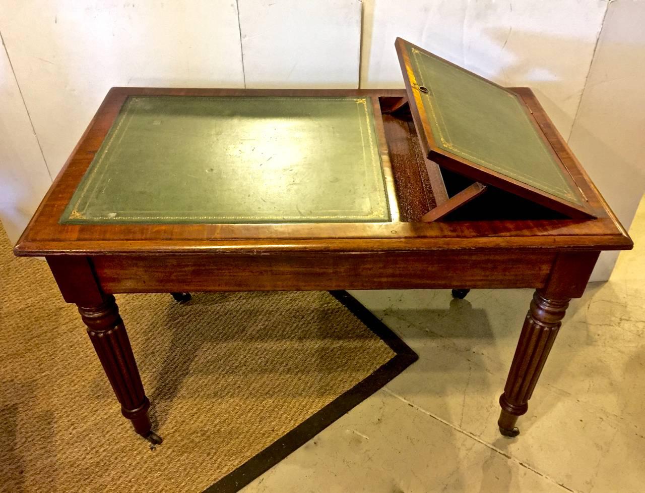 This is an uncommon form of period William IV (circa 1830-1835) desk or writing table that incorporates a book stand at one end. In addition to the book stand, the table has two side drawers at either end. The leather is an old replacement and the