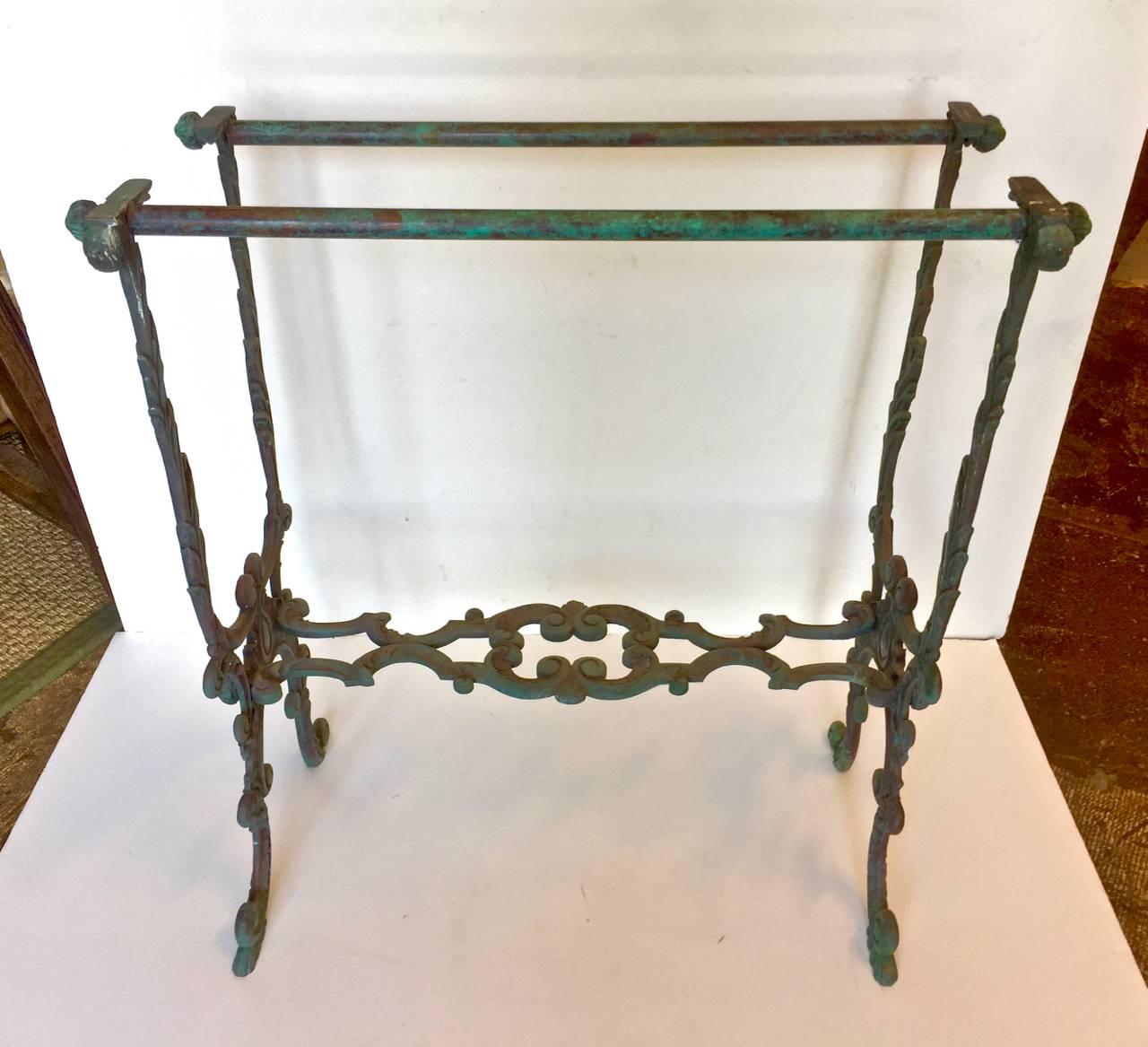 This is an unusual pair of French Bronze console table bases that date to circa 1870. The console are in a Louis XV-style and feature cast acanthus leaves and other foliage, snail form feet and beautiful finials. The cast bronze retains its original