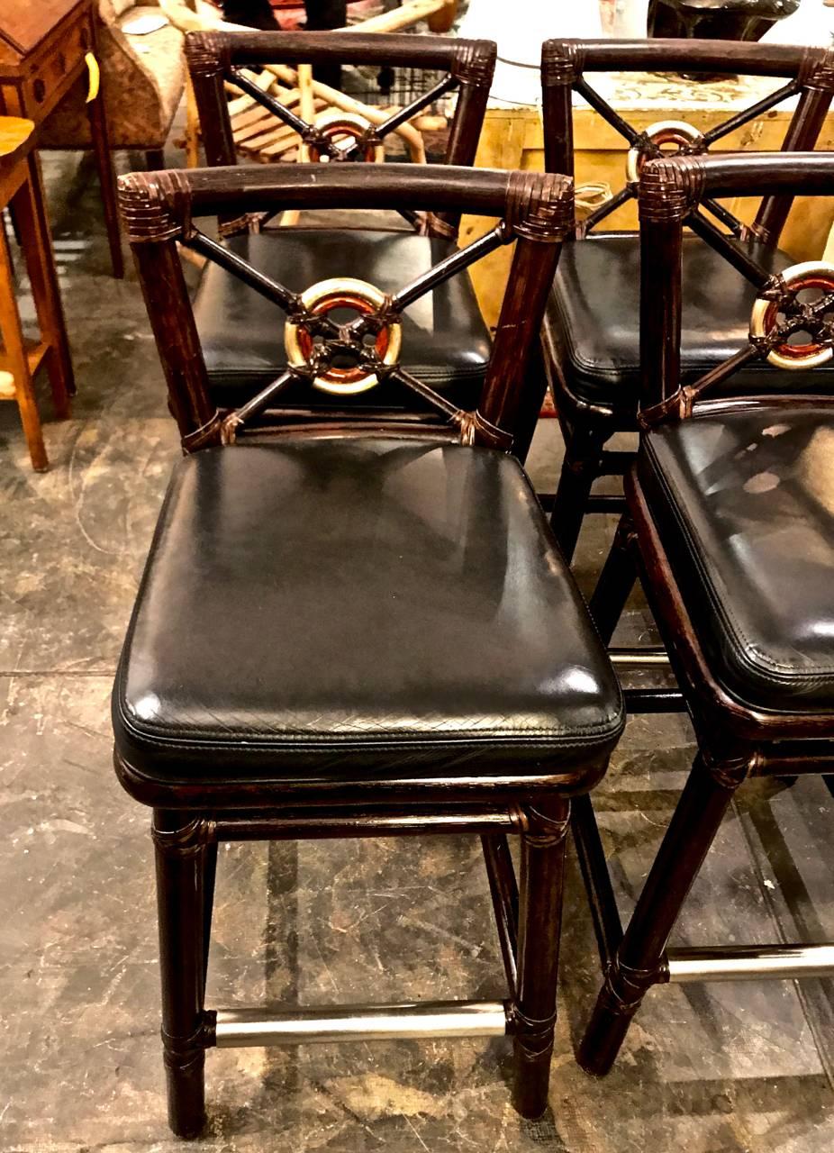 This is a great set McGuire bar stools in the target form. The stools feature gold leafed target bullseye backs, original leather seats and brass foot rails and the iconic McGuire leather strap wrapping. All of the stools are in very good to
