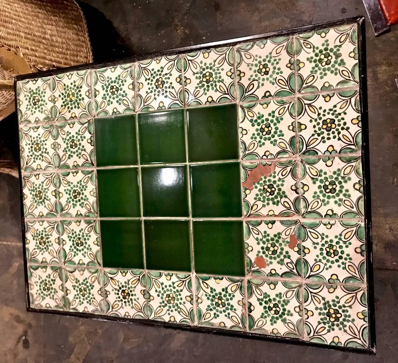This is an early 20th century heavy wrought iron occasional table whose top is composed of antique Portuguese or Spanish tiles. This would make an unusual cocktail or side table. All elements are in very good condition.