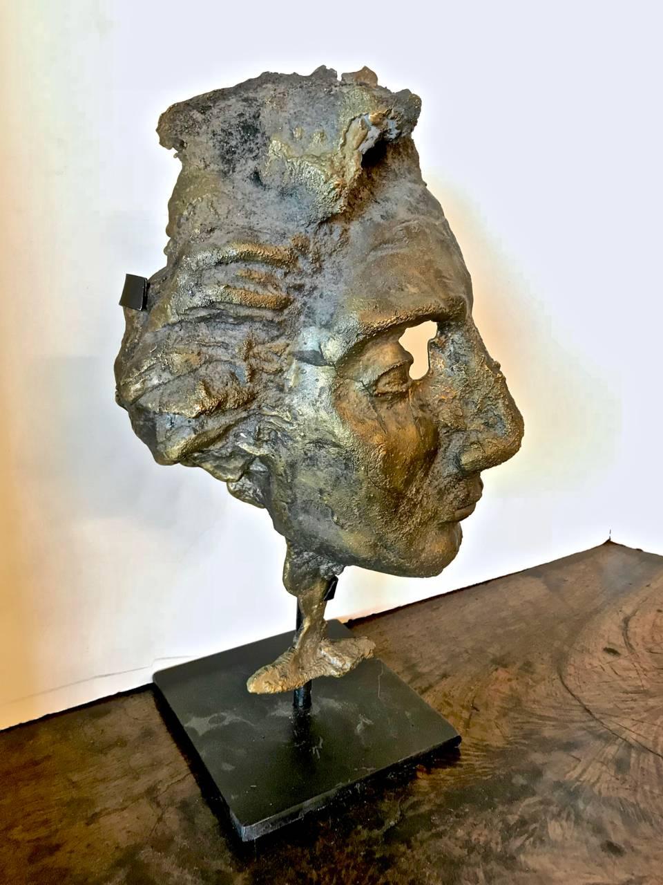 This is a Brutalist bronze casting of male bust. The bust is fitted with a custom iron Stand.