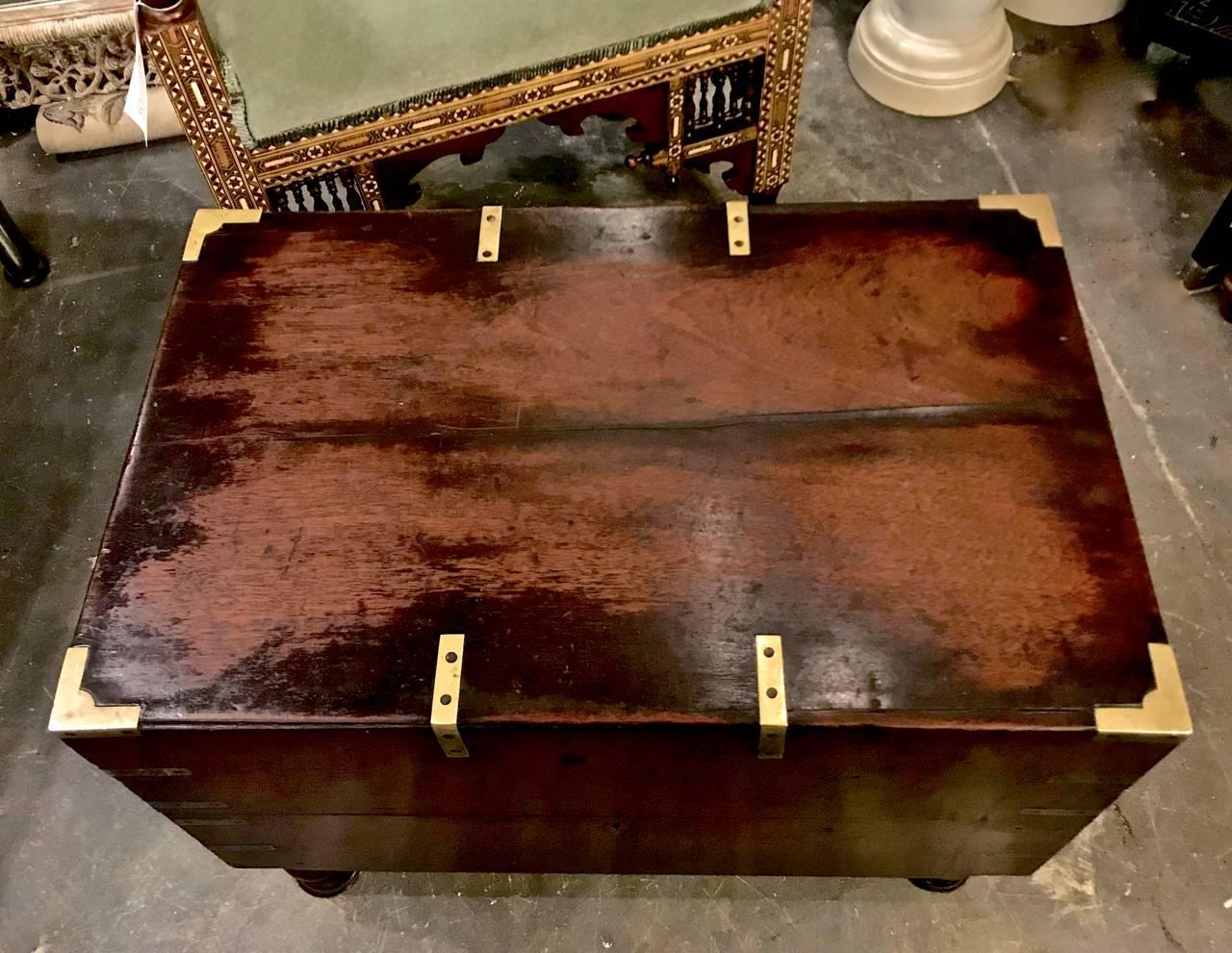 This is an unusual example of an early 19th century. English officer's campaign chest or trunk. The trunk retains its original finish, feet and brass fittings. It appears that the interior was fitted with dividers at some point. The chest is in very