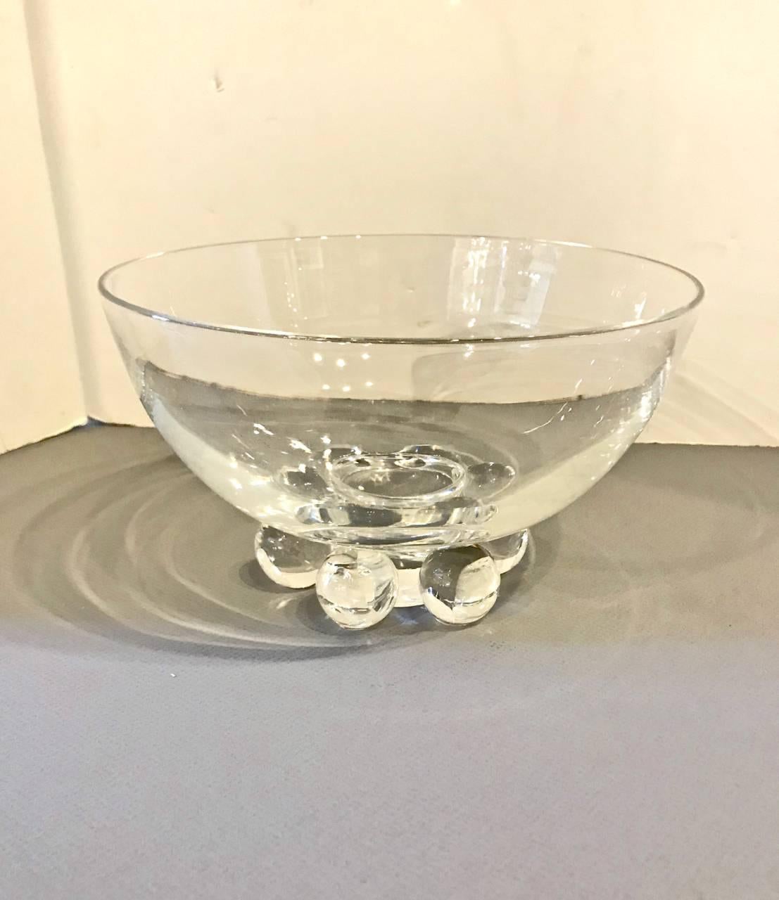 This is a great signed Steuben bowl that is raised on six glass balls and dates to the mid-20th century. The bowl is in excellent condition with the signature Steuben brilliance. The top diameter is 9 inches; the bottom diameter is 5 inches.