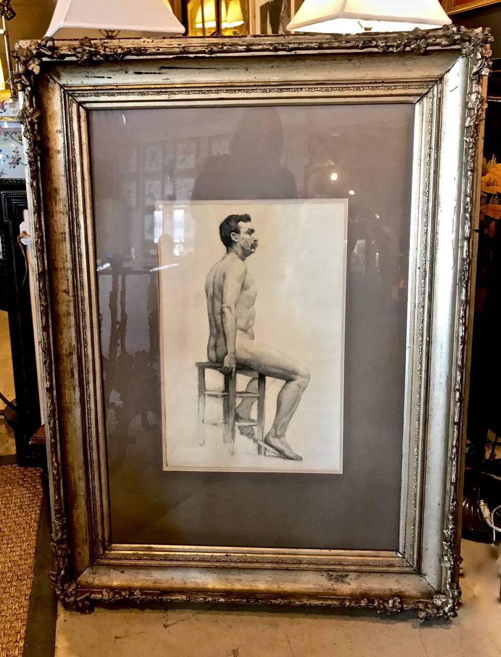 Beautifully rendered drawing of male nude. This drawing is most probably French in origin, dating to the late 19th or early 20th century. The drawing is signed with a monogram at lower which we have not researched. The antique gilt frame, although
