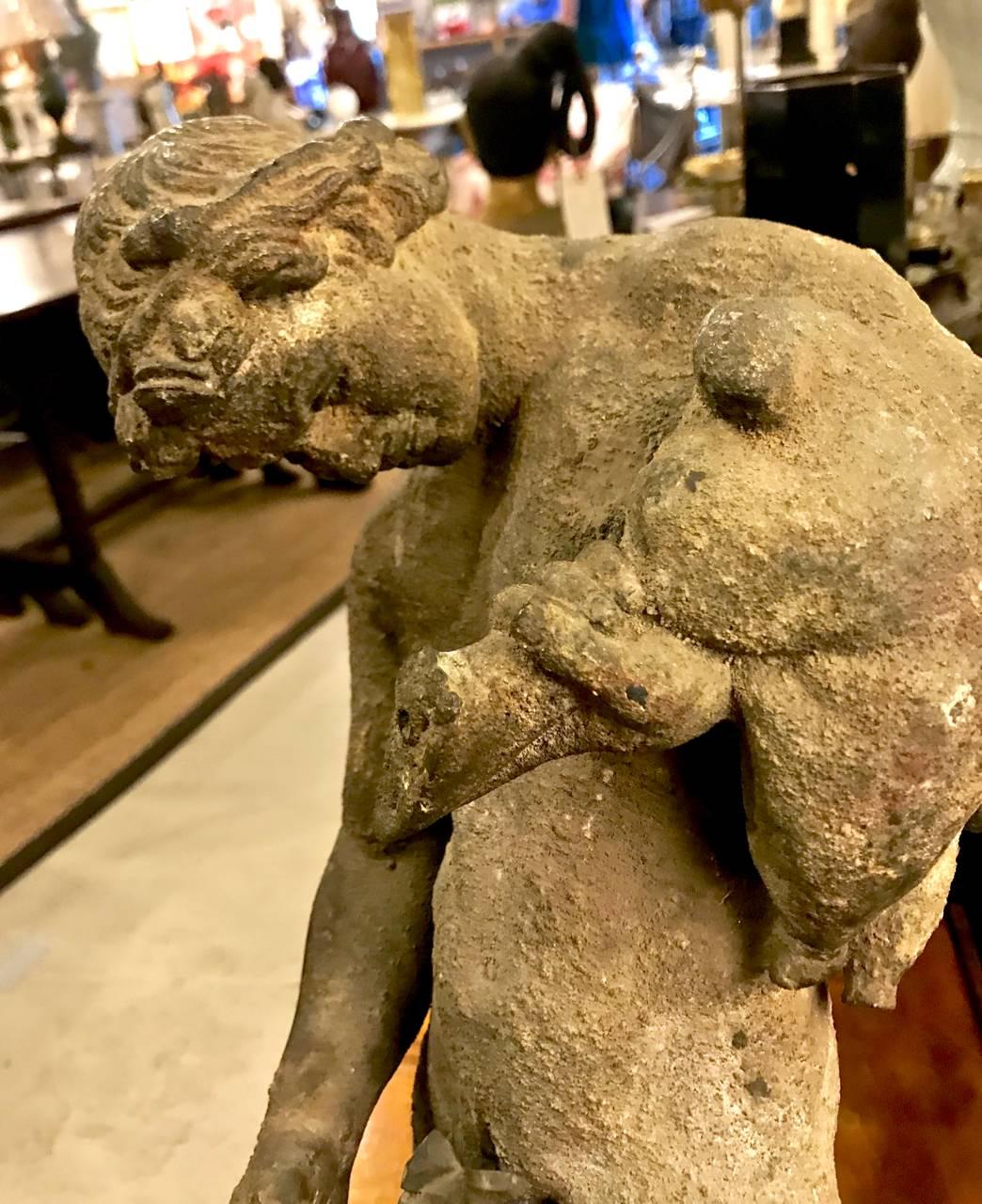 This is an exceptional 19th century cast bronze fountain of a muscled male nude figure of Bacchus pouring wine from a wine skin. The fountain is beautifully patinated revealing its many years of use. All elements of the fountain appear to be intact