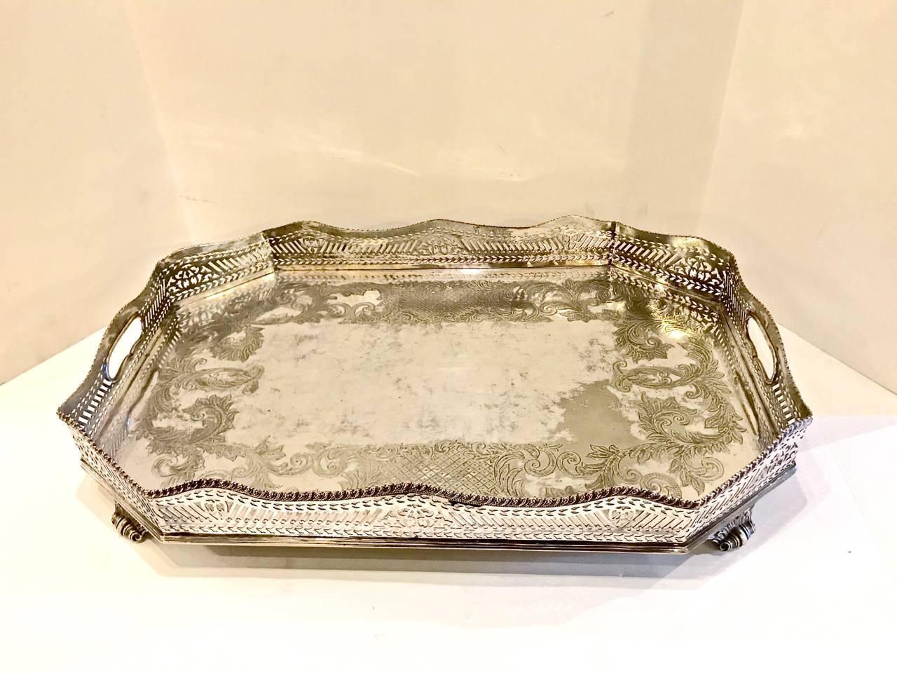 This is a 19th century (possibly early 20th century) large galleried Sheffield plate tray. The tray features a beautifully reticulated gallery and is further enhanced by acanthus scrolling feet. The tray is 8-sided and is further detailed with