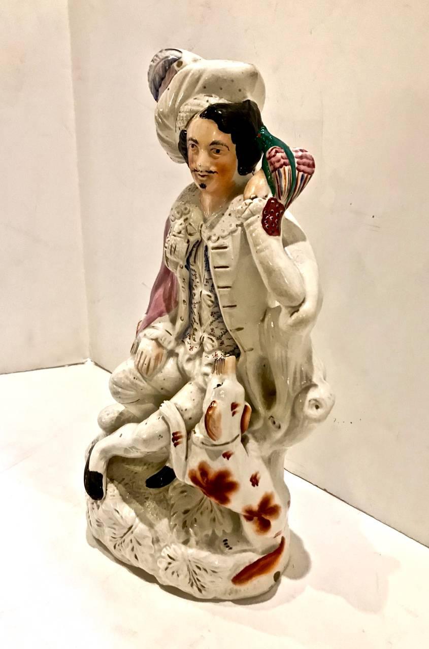 This a charming Staffordshire Grouping of a Falconer, his falcon and faithful dog, circa 1860-1880. The piece is in excellent overall condition. The base is a desirable and unusual element. The coloration is good and crisp.