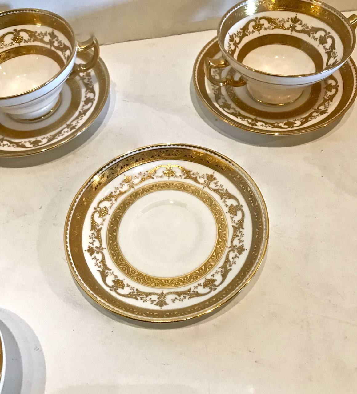 This is a beautifully heavily gilt decorated set of eight Minton Bouillon or cream soup cups and saucers that dates to the first half of the 20th century. The quality of Minton porcelain is exceptional and highly desirable. Three additional cups