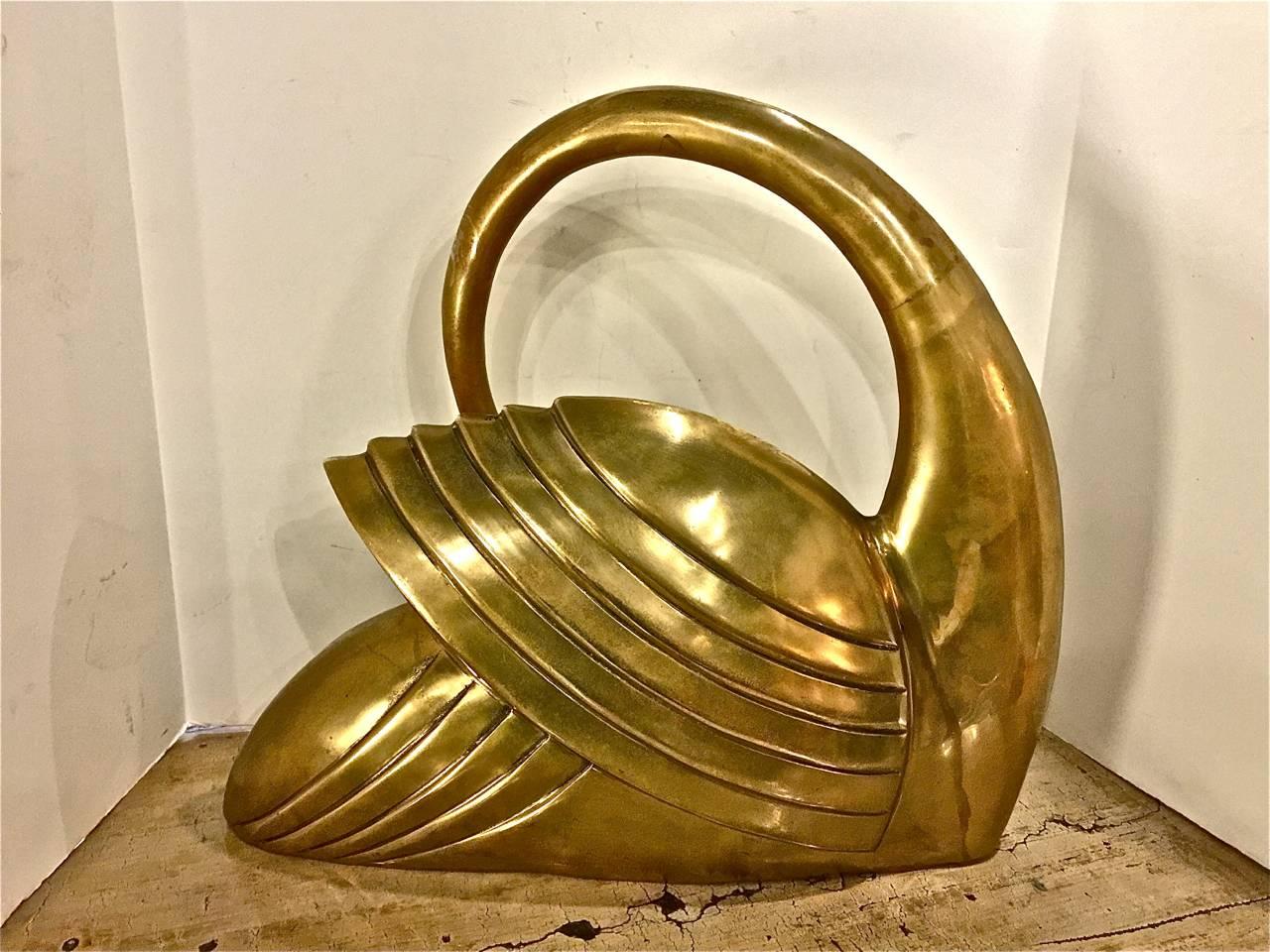 This is a stunning large and heavy brass swan that dates to circa 1975-1980. The Swan is designed in an elegant and graceful modernist style. It would act as a great counterpoint to almost any design theme.