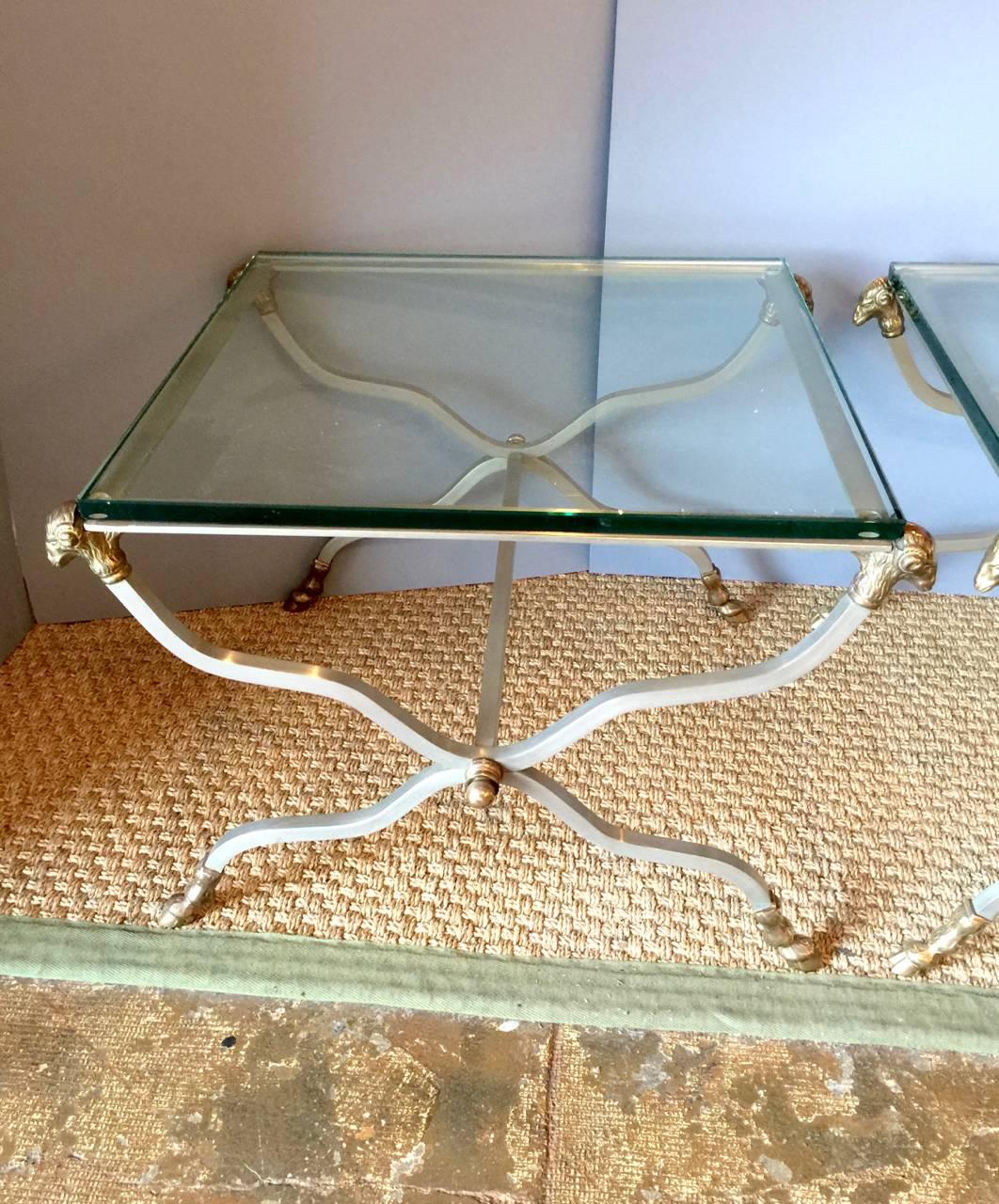 This is a pair of Jansen-style neoclassical side tables that were created in Italy during the 1950s. The tables are crafted of steel, brass and thick glass tops; all elements are original.