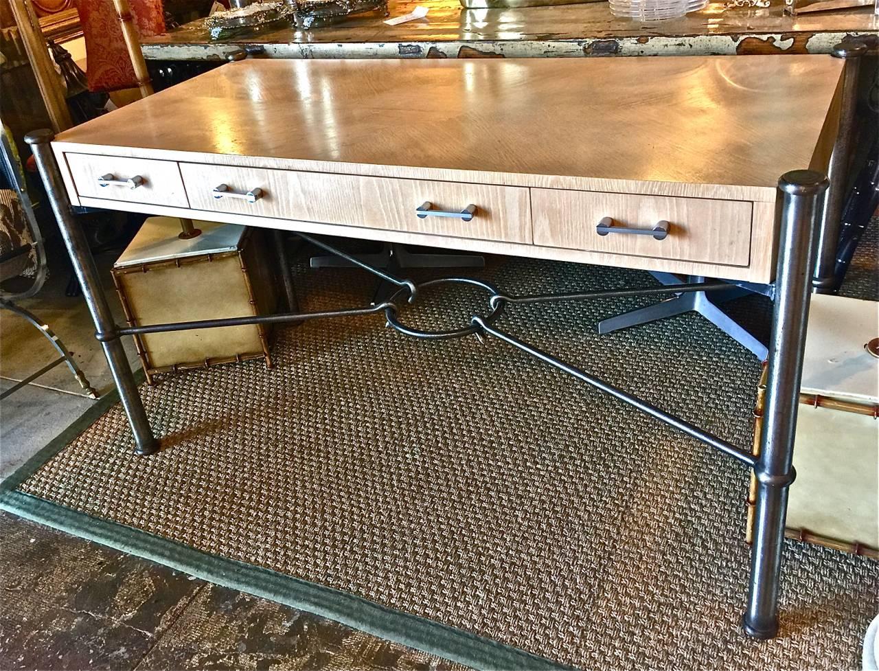 This is a stunning Jay Spectre for century writing desk that dates to circa 1970-80. The desk features a three drawer cerused oak writing surface supported by ringed steel columns with a forged iron center stretcher. The desk is in very good