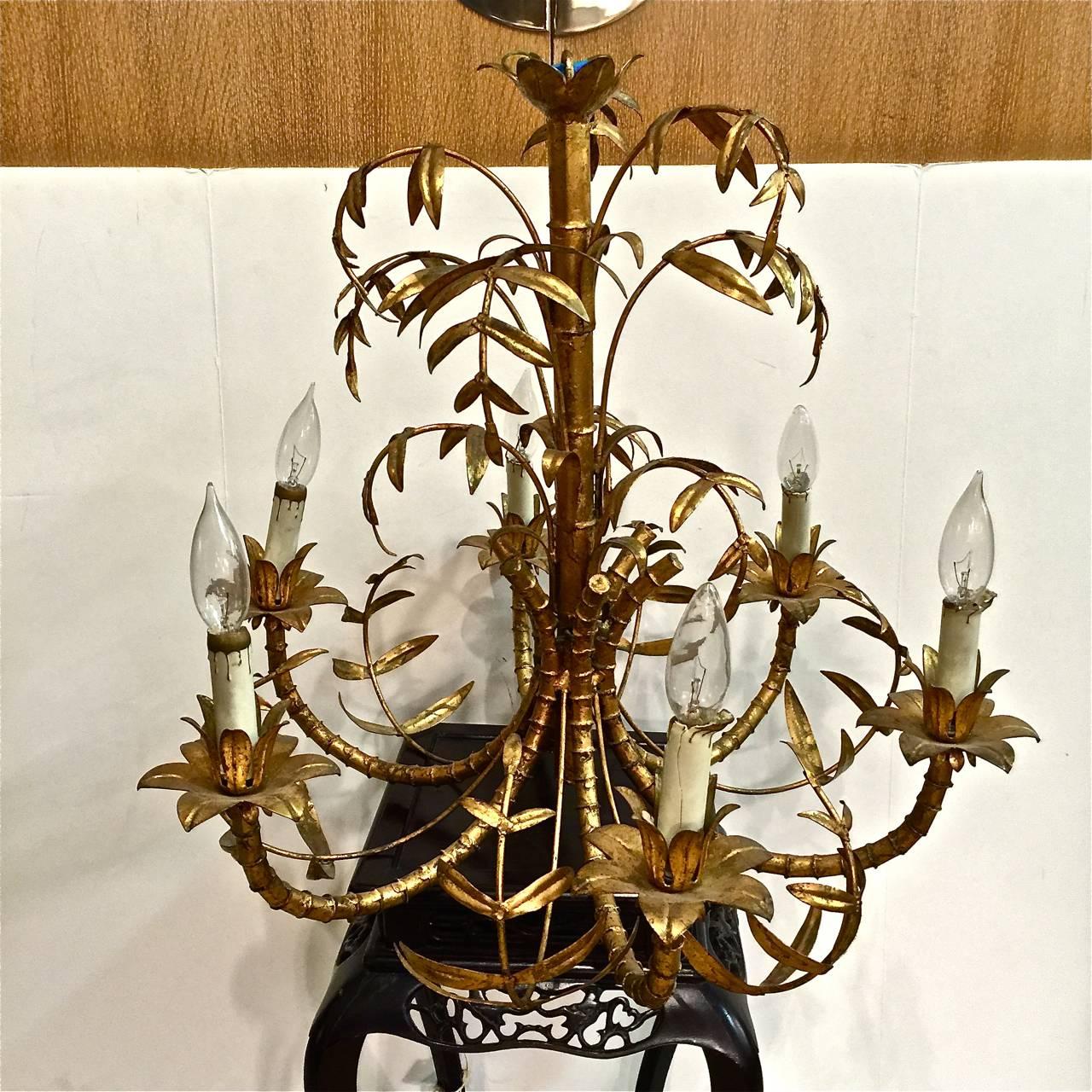 This is a charming small-scale faux bamboo chandelier that dates to circa 1960. The chandelier is well-detailed and retains its original gold leaf and is in very good condition. Height measurement is to top of chandelier, excluding chain.