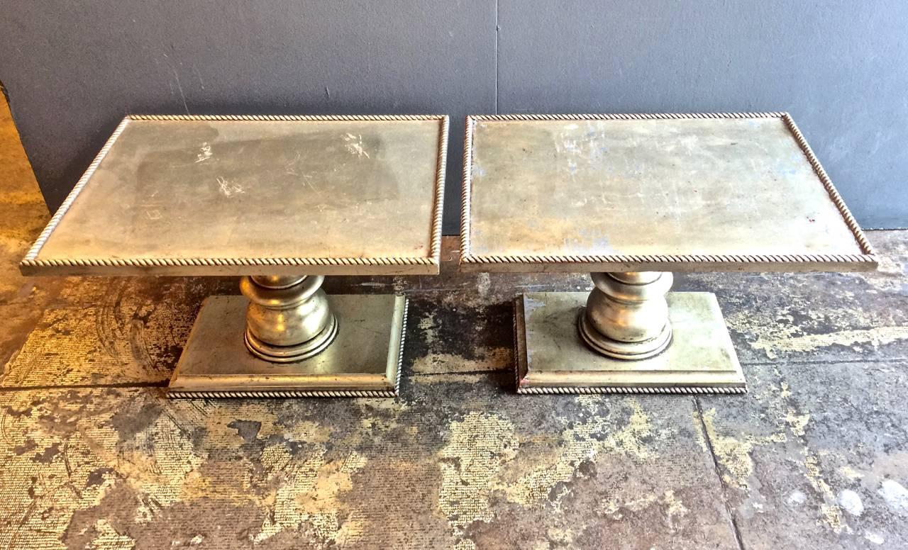 This a fun pair of circa 1980s hand-carved rope side tables that have been sheathed in a white gold leaf, rather than the more common yellow gold leaf. The tables are in overall very good condition with heavier patination to the gold-leafed top