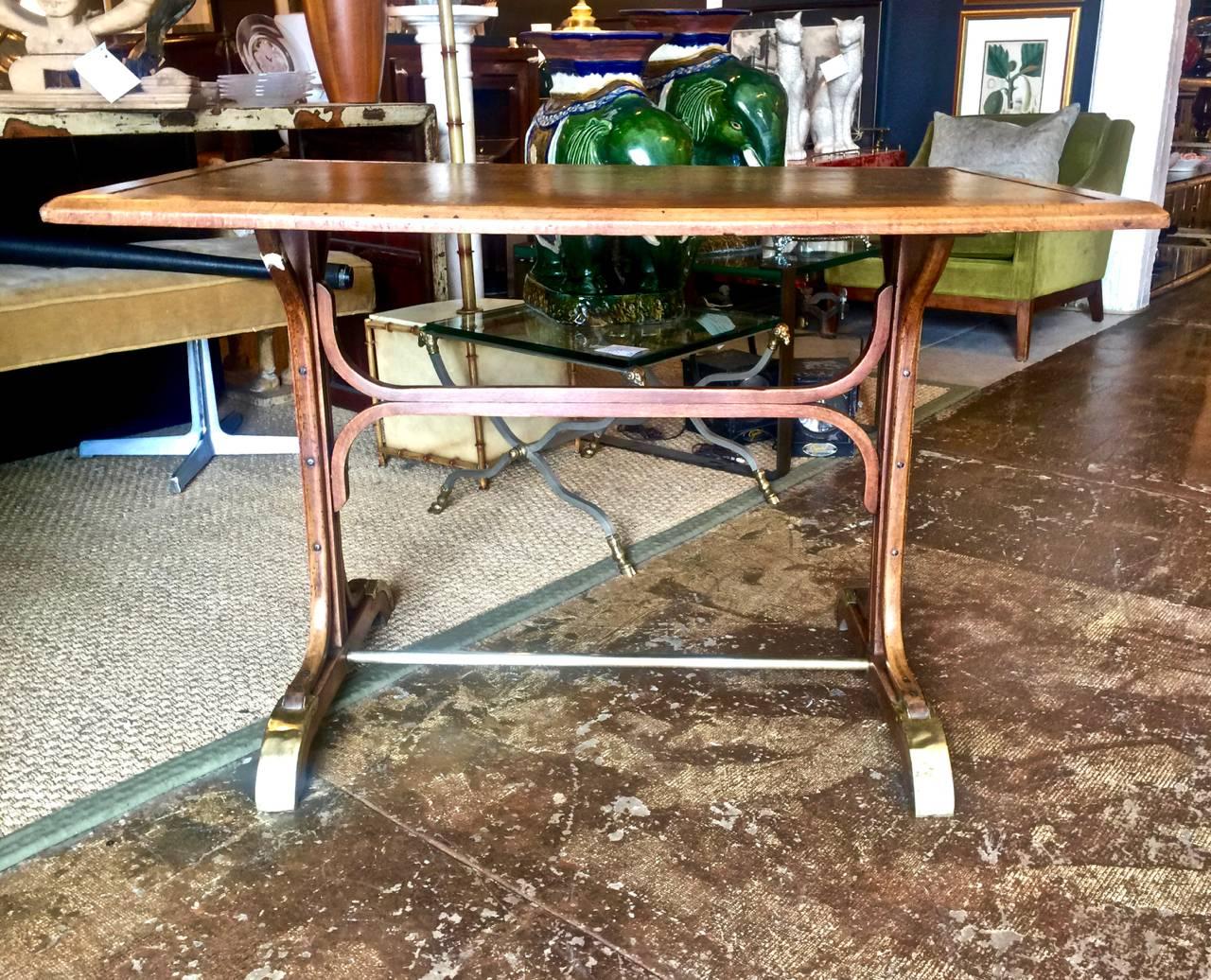 This is a charming original Thonet bistro table that retains all of its original elements with the exception of the replaced leather surface. The size of the table make it perfect for an intimate breakfast table, an unusual writing table or games