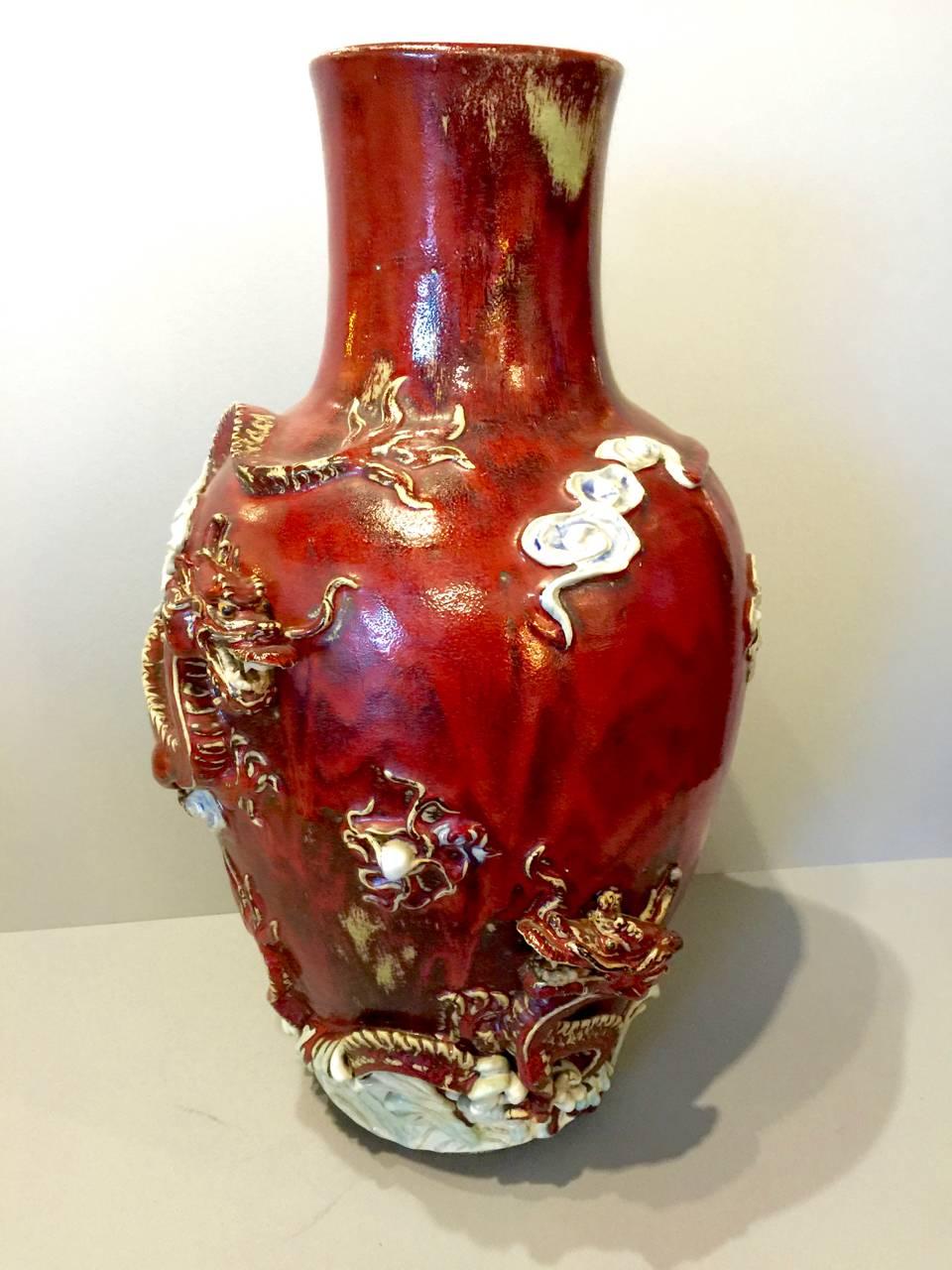 This is a stunning artist signed large Sumida vase decorated with a pair of high relief dragons, flaming pearls, waves, clouds and a poem. This a large heavily potted vase and unusual in that the high relief detailing depicts dragons with flamings