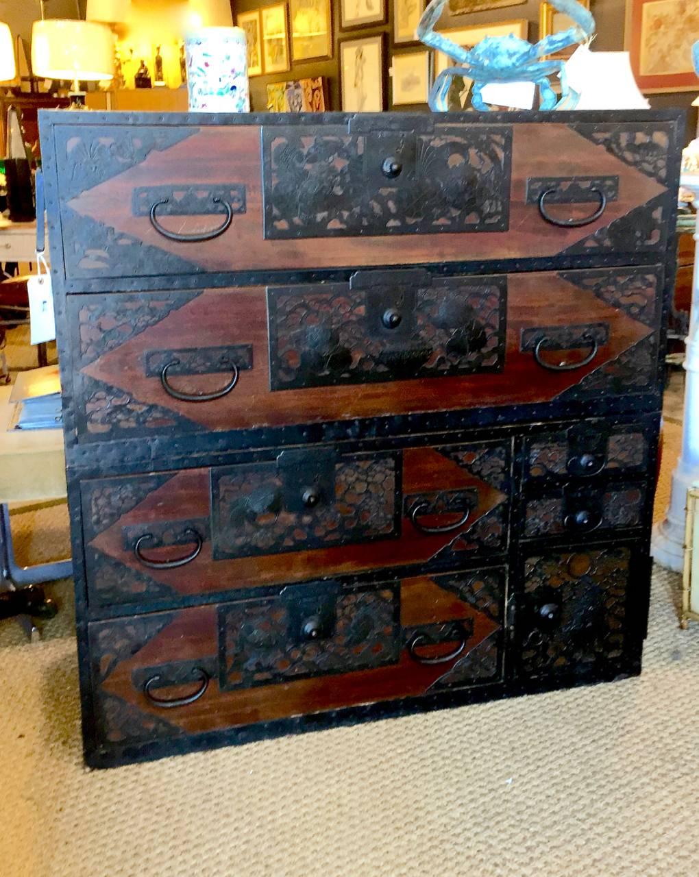 This is a stunning late Meiji Period (circa 1880-1890) Sendai Tansu. This particular tansu is the more desirable two-part form and was used to store Samurai clothing. Sendai Tansu are characterized by beautiful forged and cast iron fittings. The