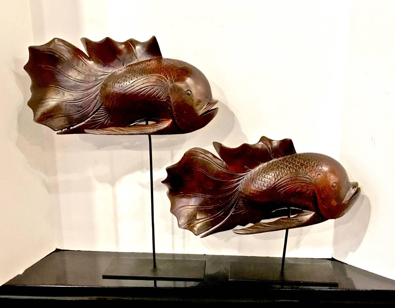 This is a great pair of carved Japanese Koi fish on stands that date to circa 1960-1970. Both koi are in overall very good condition and have just the right amount of patina. The koi are displayed on metal stands.