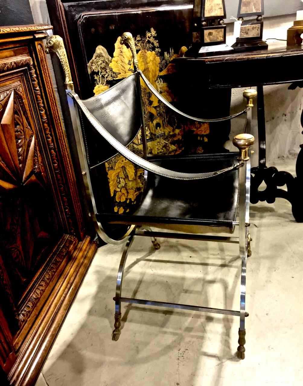 This is an example of the iconic Jansen Curule or Savonarola chair. The chair is beautifully detailed in steel, cast brass and leather. The Jansen Savonarola chair is distinguished by it's intricately cast brass ram's head finial and paw feet.
This