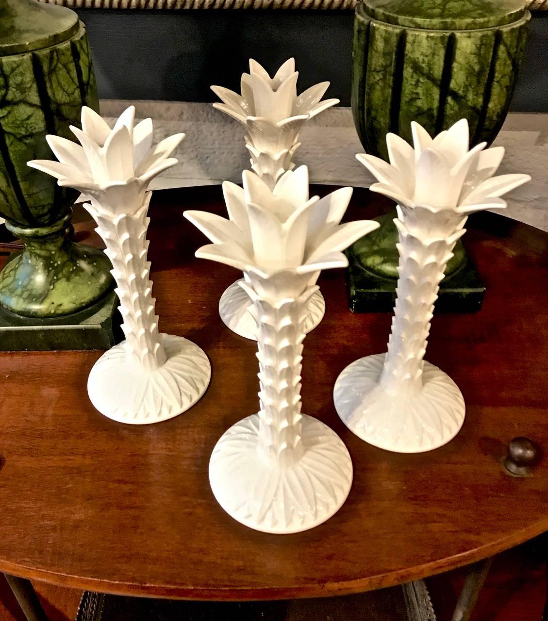 This a great set of four Fitz & Floyd pottery palm tree chinoiserie candlesticks in an ivory tone. The candlesticks are dated 1975. It is unusual to find a set of four of these highly decorative candlesticks.