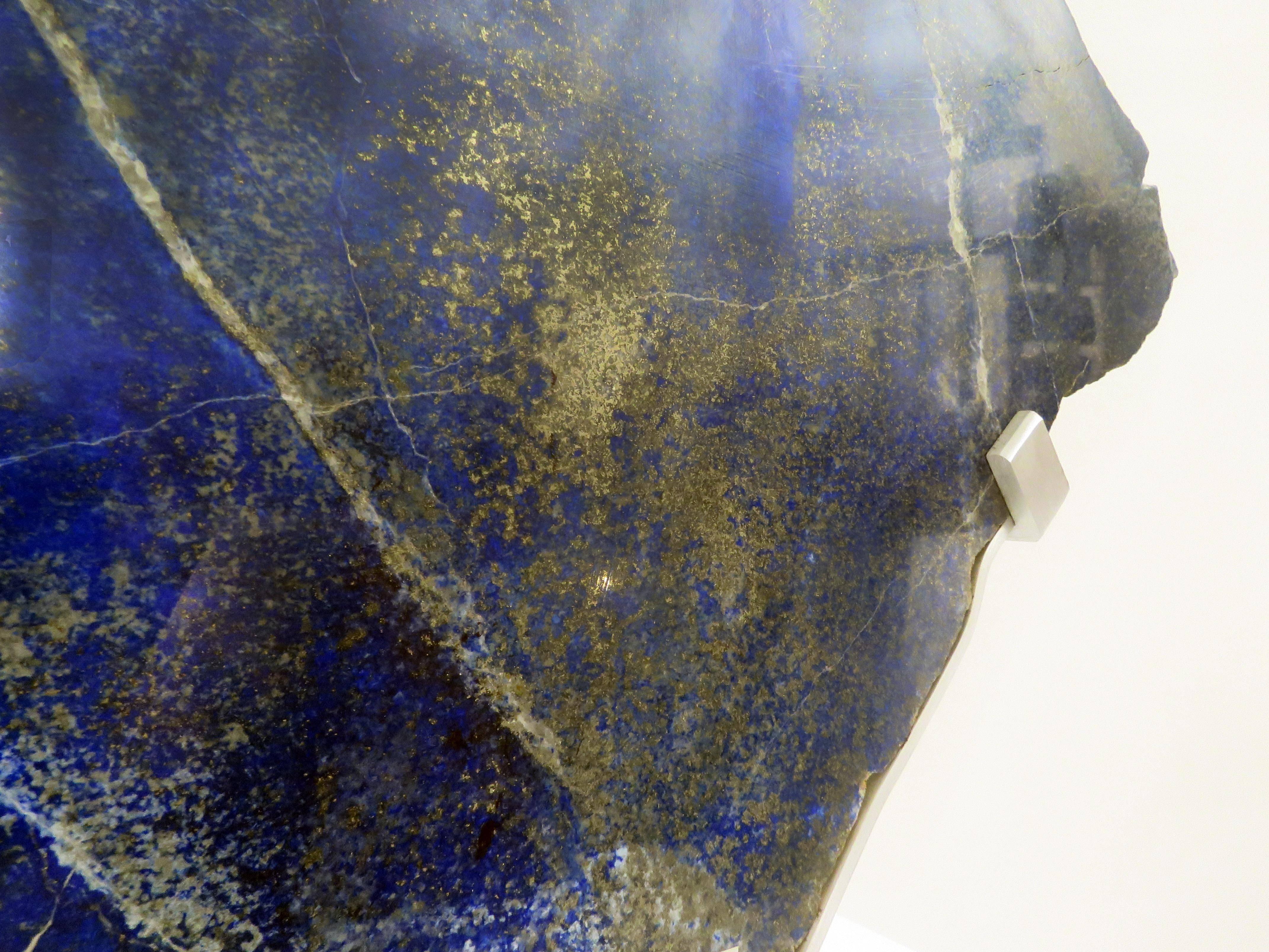 Lapis Lazuli is a deep blue metamorphic rock used as a semi-precious stone that has been prized since antiquity for its intense color.
It is a combination of lazurite, main constituent, white calcite and pyrite.
The lapis sculpture is 22” x 1” x