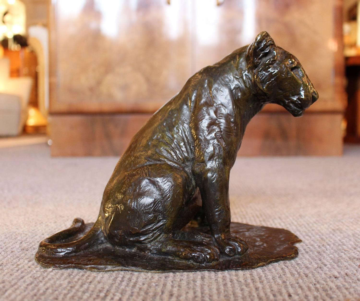 Lionceau Assis, by Roger Godchaux (1878-1958). A patinated bronze study of seated lion cub set over an integral, naturalistic base. Cast with fire perdue method by Susses Frères Editeurs Paris.

Signed Roger Godchaux to bronze.
  