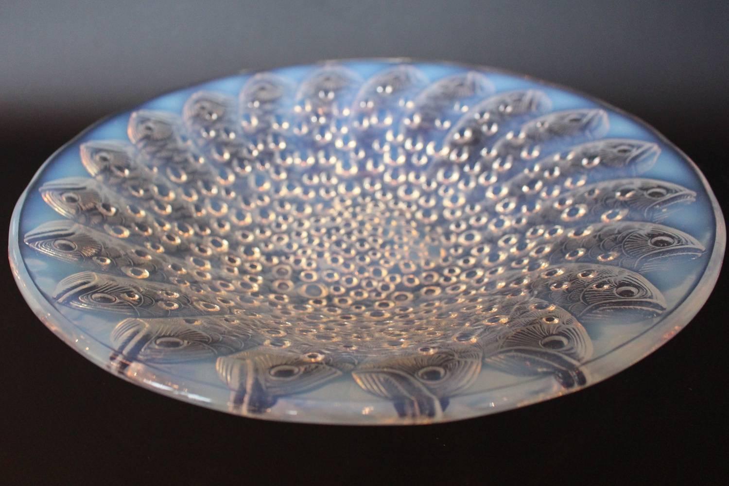 Roscoff, an Art Deco glass bowl by René Lalique (1860-1945). Decorated with a raised, design of concentric fish emerging from a mass of swirling bubbles.
Marcilhac Catalogue Raisonné p.306

Etched R Lalique France to base

Measures: Diameter