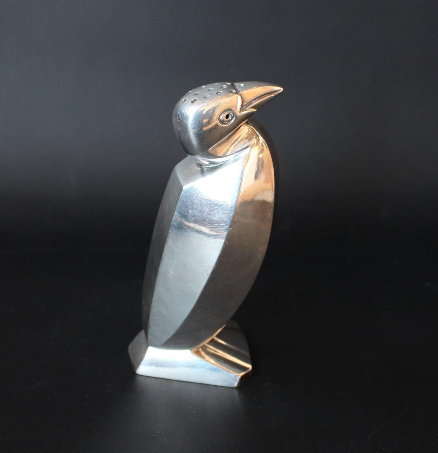 An Art Deco silver plated shaker in the form of a stylized penguin. Designed by Edouard Marcel Sandoz for Gallia (Maison Christofle). Numbered 0024 and stamped O. Gallia to base.

 