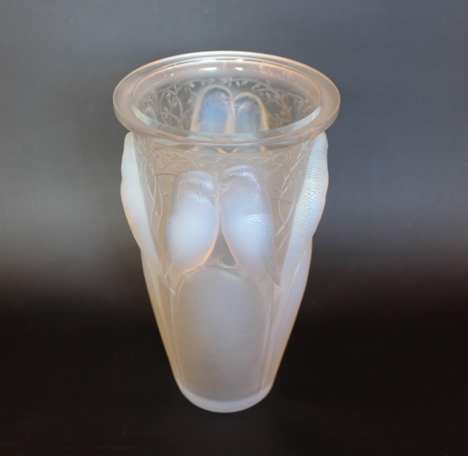 Ceylan, an Art Deco glass vase by Rene Lalique (1860-1945). A frosted and opalescent glass vase, relief decorated with pairs of lovebirds and vines.

Etched R Lalique France and number 905 to underside.

Literature: Marcilhac, R Lalique