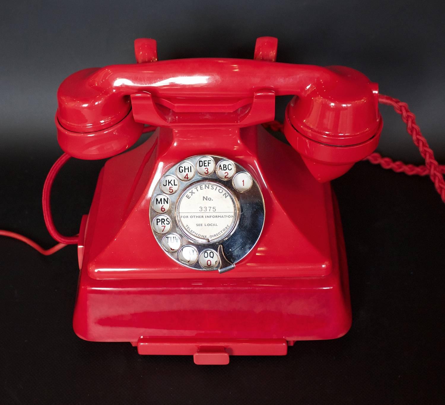 An Art Deco 'King Pyramid' telephone in rare and original fire red bakelite. Produced by the GPO (General Post Office), this is model number 1/232 with attached bell set and integral drawer.
  