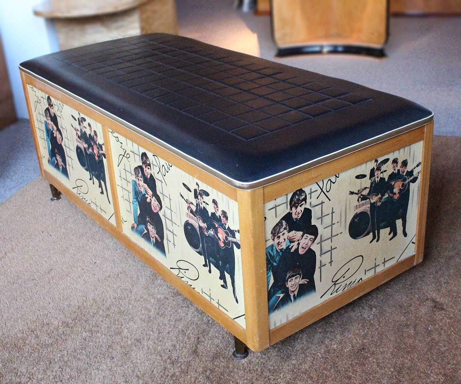 A Beatles memorabilia chest produced by the Avalon furniture company. Set over metal feet and covered over and varnished with the Beatles wallpaper produced by Wall Paper Manufacturers Ltd. of Manchester in 1964. Original vinyl upholstery and