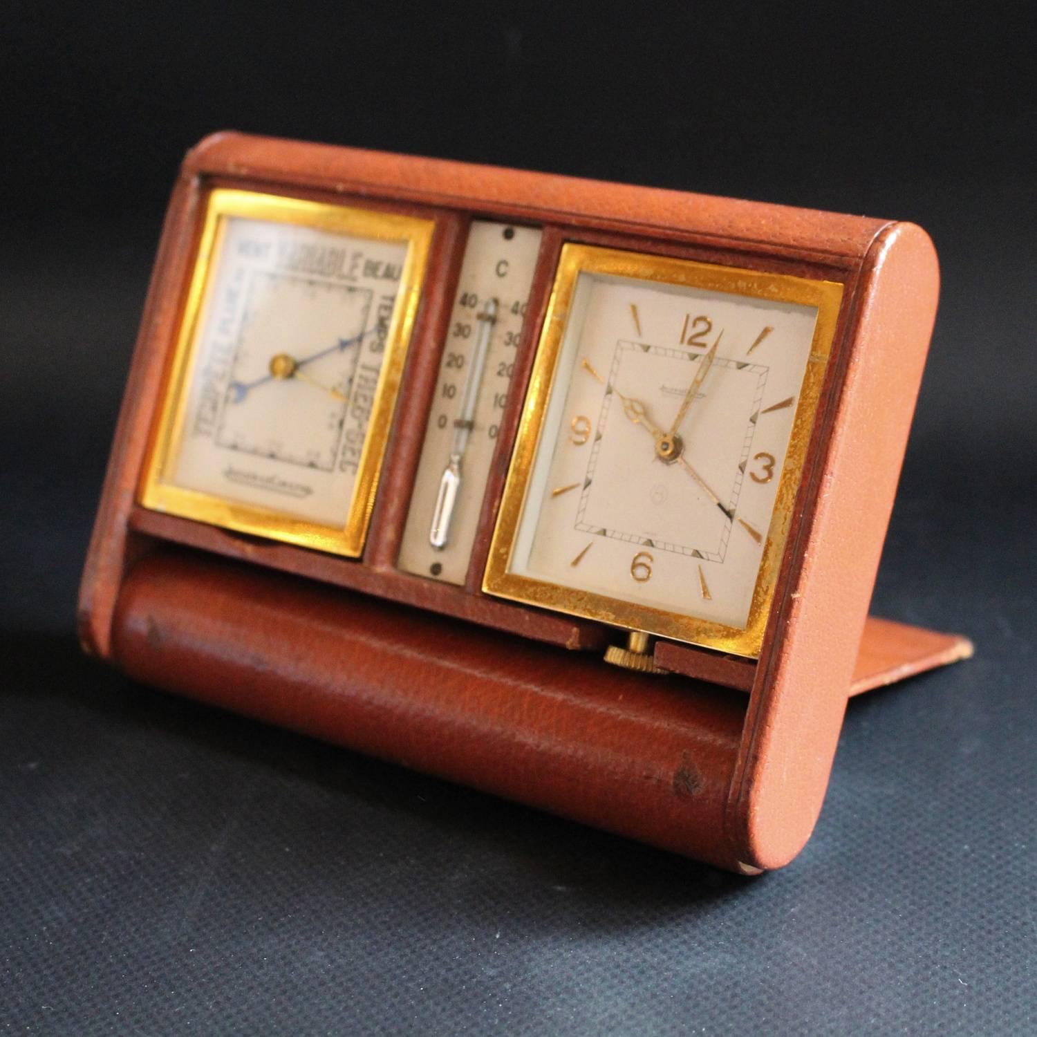 An Art Deco, Jaeger-LeCoultre travel compendium. Comprises 8 day movement clock, barometer and thermometer set in a pigskin folding case.

Measures: H 11cm, W 15cm, D 3cm closed, 10cm open.
  