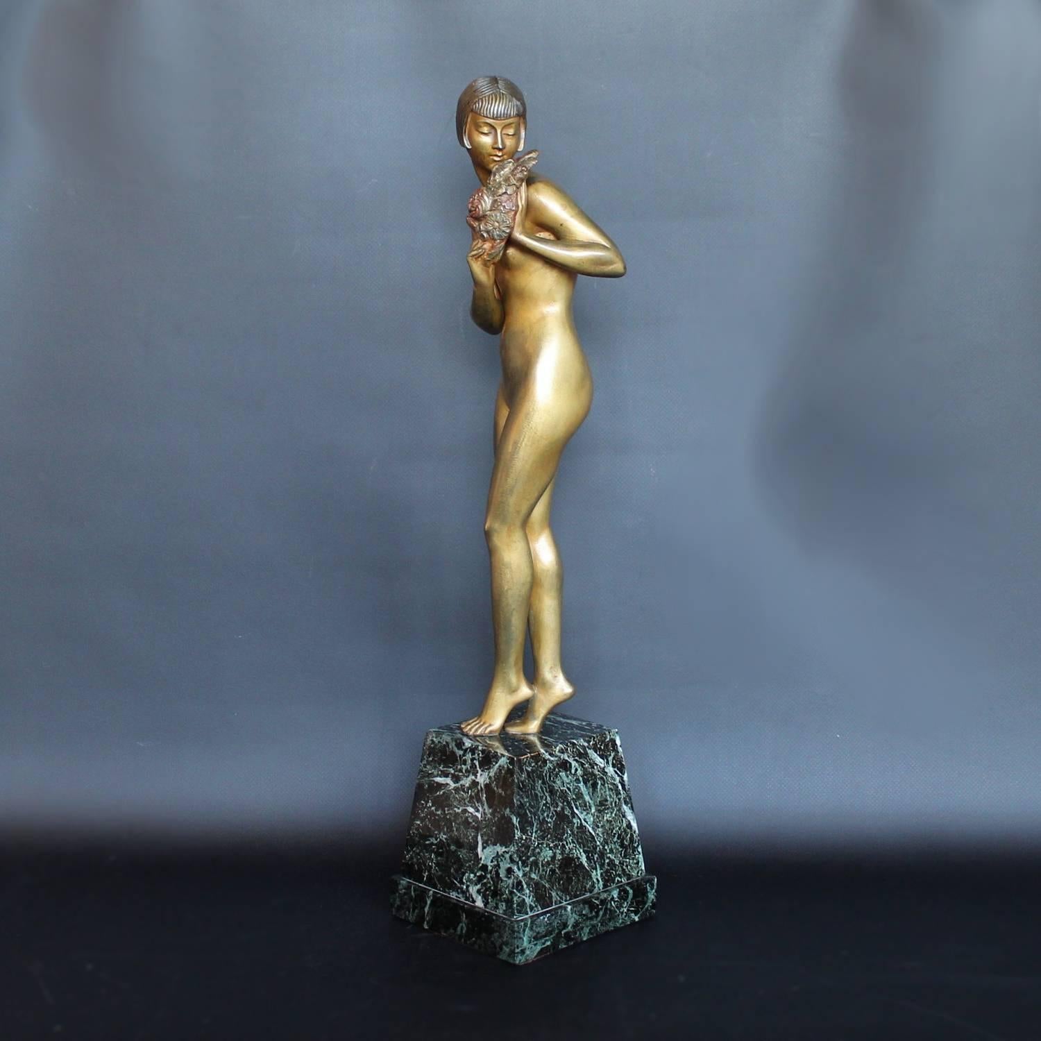 Lady with flowers, an Art Deco sculpture by Pierre Le Faguays (1870 -1938). A cold painted bronze figure of a lady balancing on her toes over a marble plinth, holding a spray of flowers at her shoulder.

Signed Le Faguays to marble, stamped for