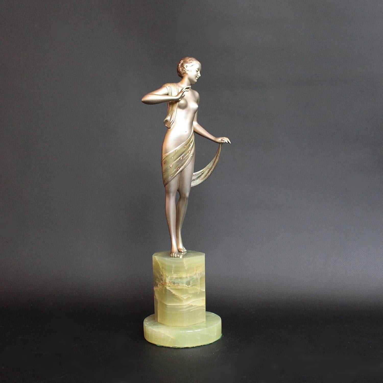 Scarf Dancer, an Art Deco. cold painted bronze figure by Josef Lorenzl (1892-1950). Depicts a young lady draped elegantly in a patterned scarf, set over a green onyx plinth.

Signed J Lor to bronze.


 