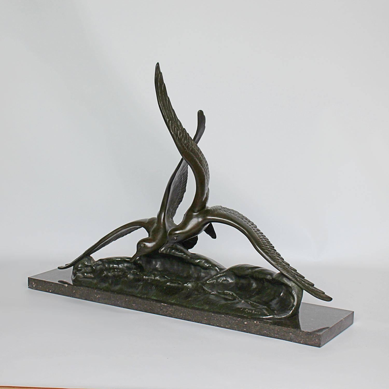 An Art Deco, patinated bronze sculpture of two seagulls swooping over the waves. Signed I Rochard to bronze. Signed for Reveyroli foundry. Set over a marble plinth.
 