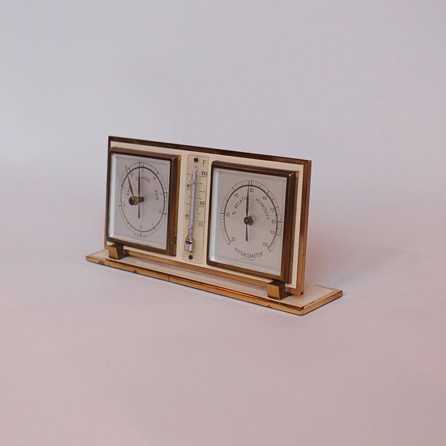 A barometer, thermometer hygrometer set presented in a painted and polished brass frame.

Made in West Germany to front.

  