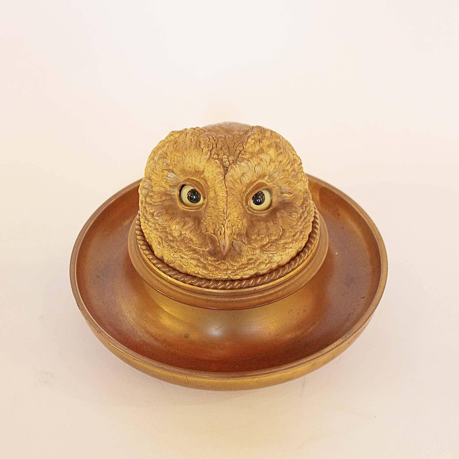 A gilt bronze inkwell in the shape of a detailed owl head, with original glass eyes, set over an integral tray. Charming characterisation and fine detail. Removable inkwell with original glass.

  
